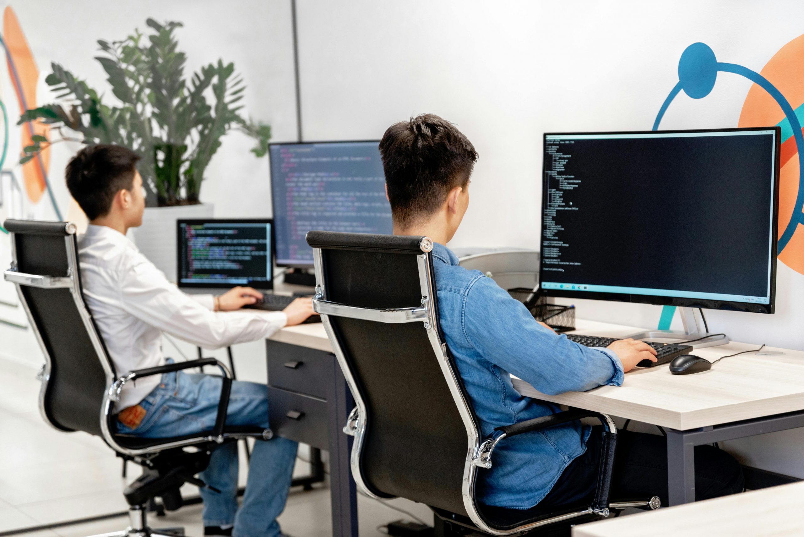 Two people working on their computers